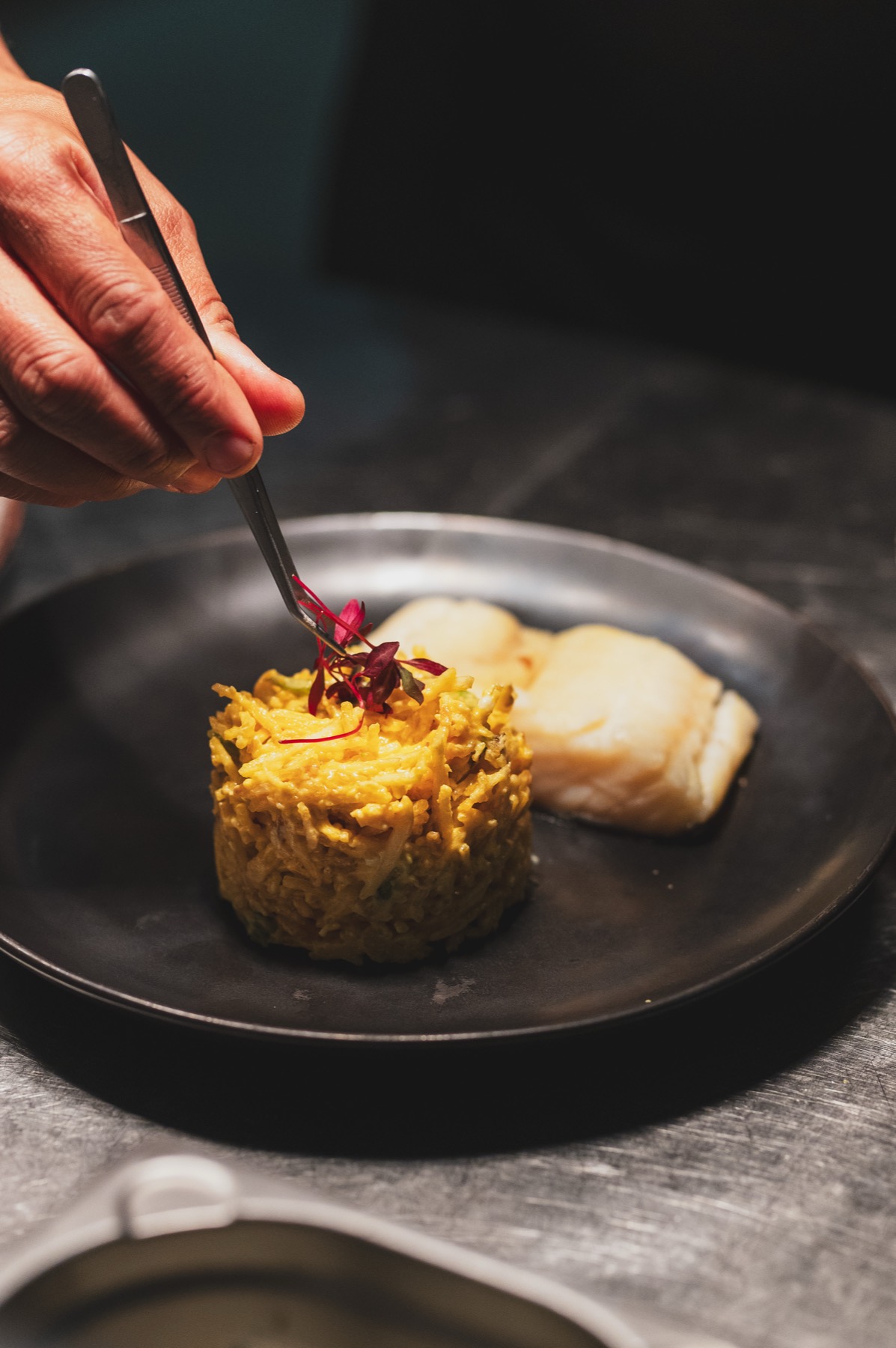 Um prato a ser finalizado à mão na cozinha da Villa Sabóia